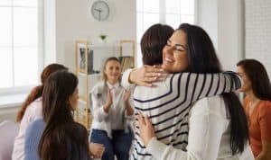 group of smiling women two hugging